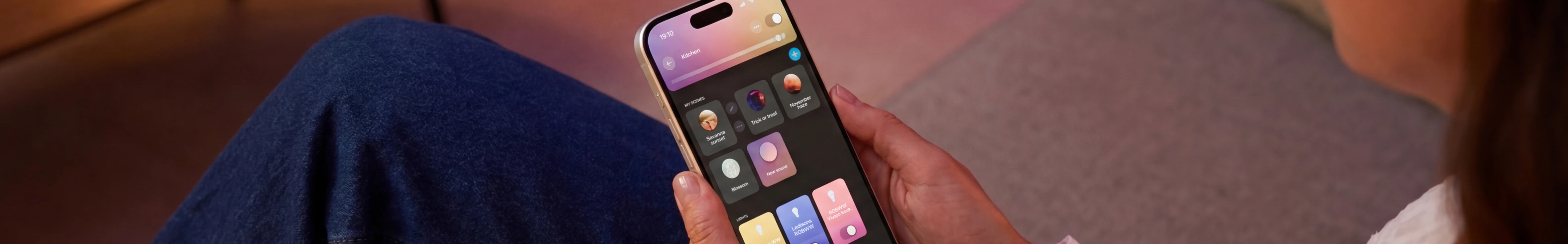 Persoon bedient slimme LED-verlichting met een app op smartphone in de woonkamer